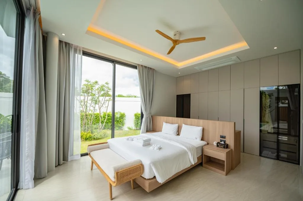 Villa master bedroom with garden view and ceiling fan