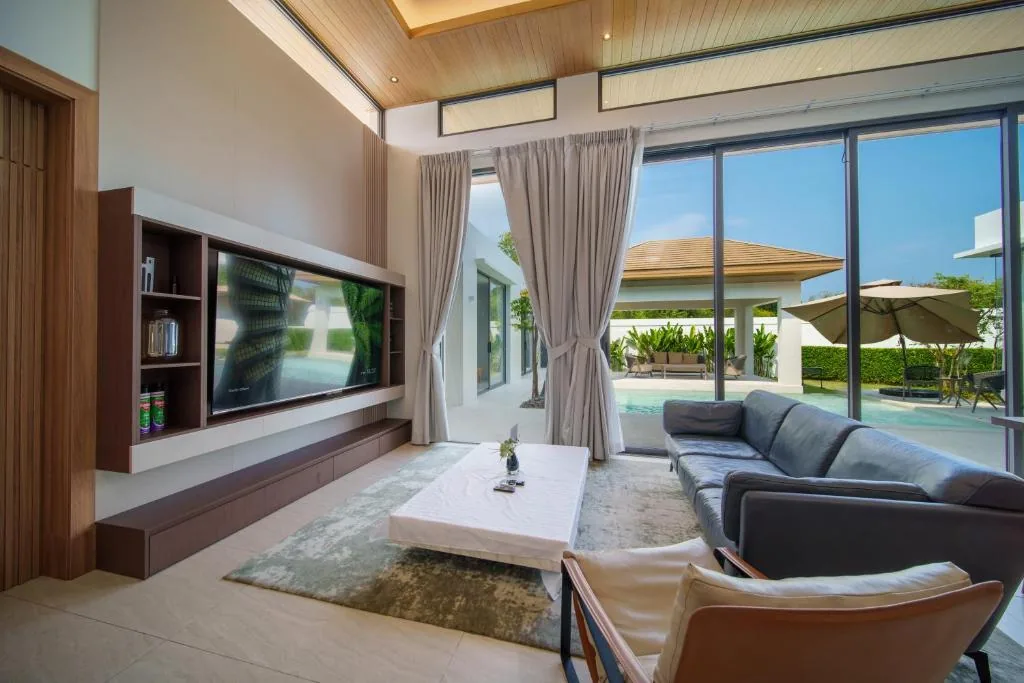 Villa living room with floor-to-ceiling windows overlooking pool