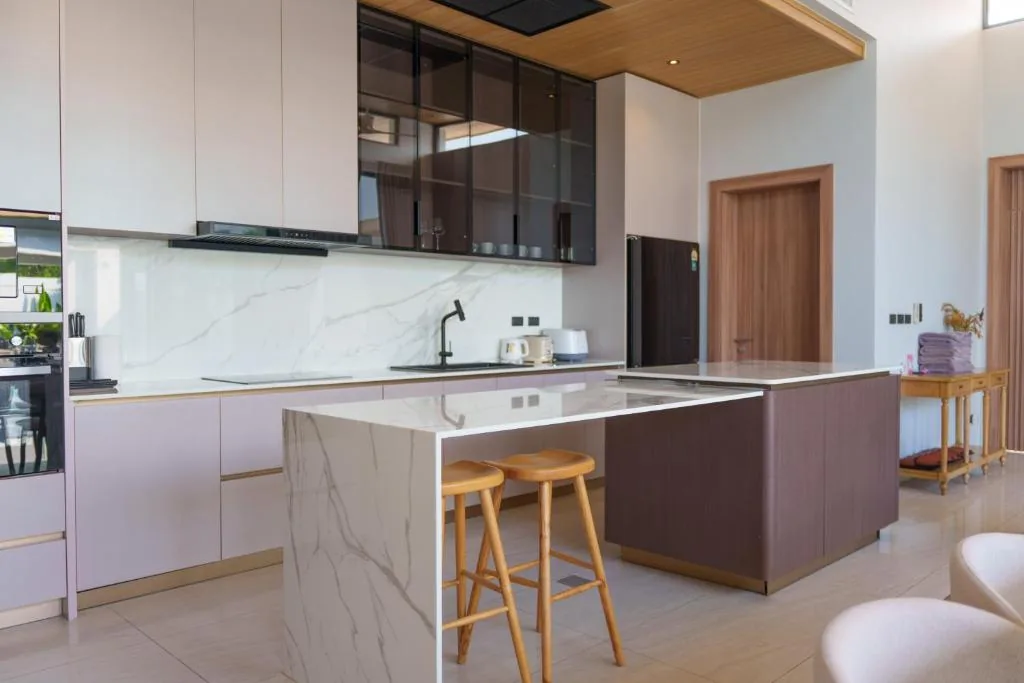 Villa modern kitchen with marble island and bar stools