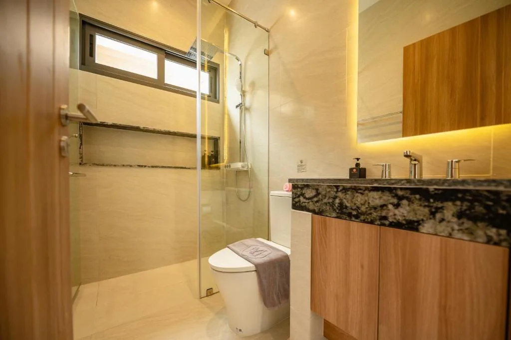 Villa en-suite bathroom with glass shower and marble vanity