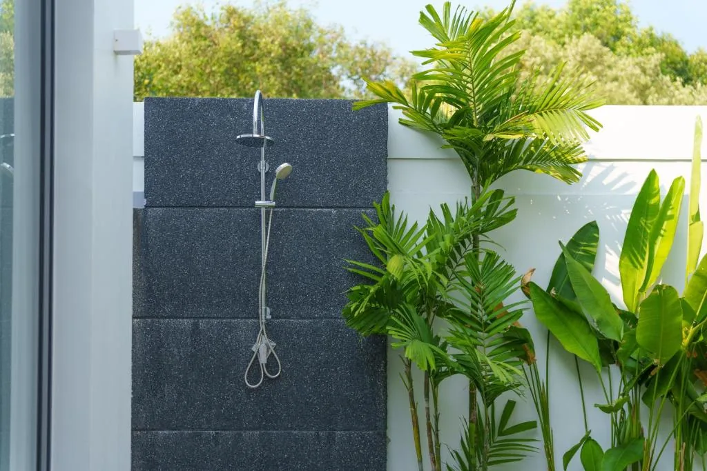 Villa outdoor shower surrounded by tropical plants
